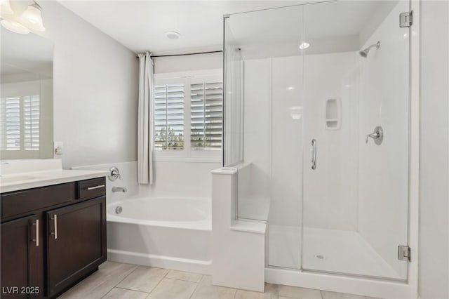 bathroom with separate shower and tub, vanity, and tile patterned floors