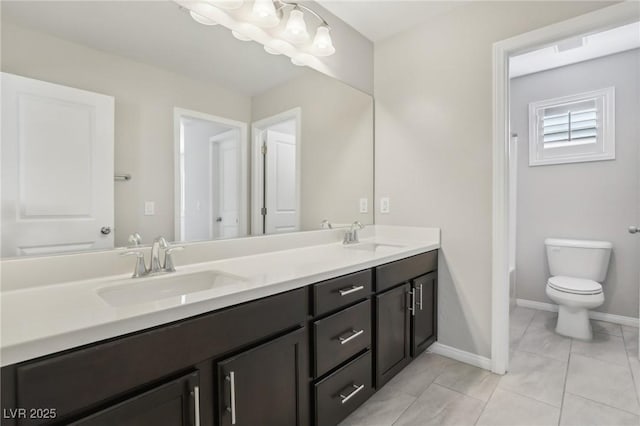 bathroom featuring toilet, tile patterned flooring, and vanity