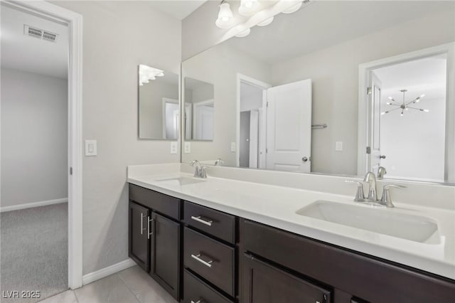 bathroom featuring vanity, tile patterned floors, and a chandelier