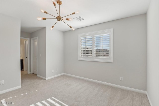 spare room with light carpet and a chandelier