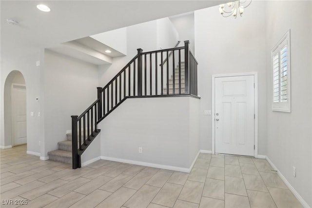 foyer entrance featuring an inviting chandelier