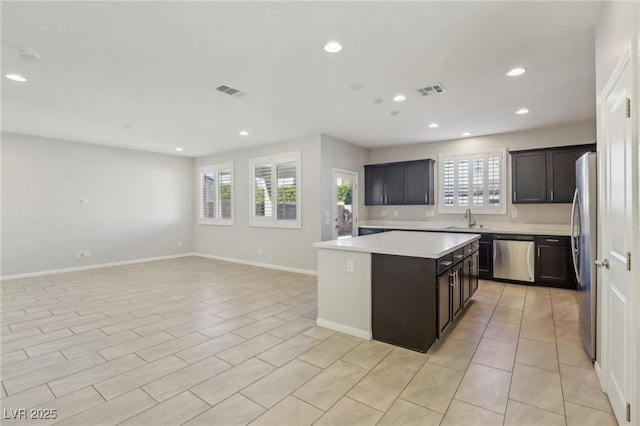 kitchen featuring sink, stainless steel appliances, and a kitchen island