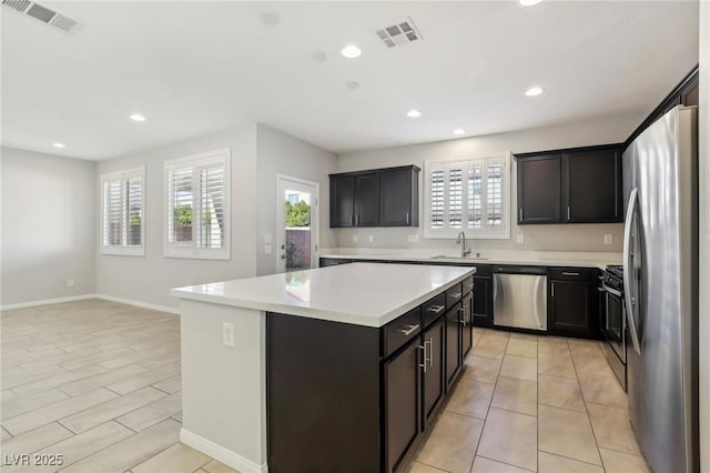 kitchen with sink, stainless steel appliances, and a center island