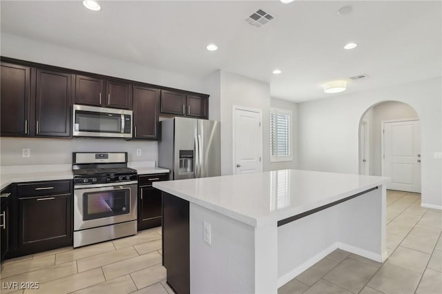 kitchen featuring dark brown cabinetry, a center island, and stainless steel appliances