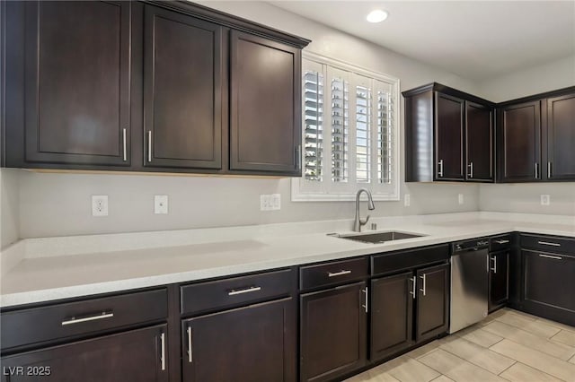 kitchen with stainless steel dishwasher, dark brown cabinetry, and sink