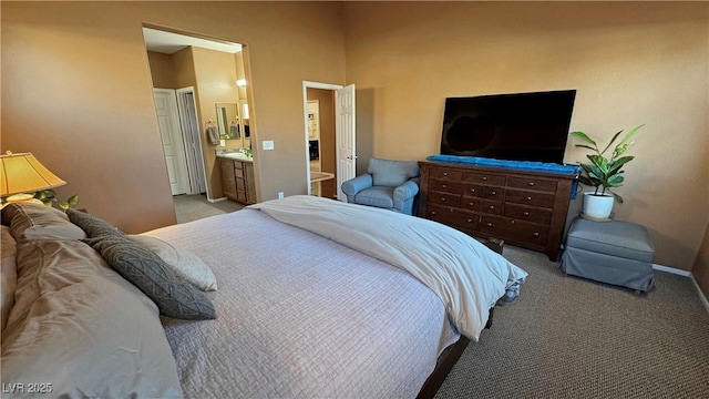 bedroom featuring sink, light carpet, and connected bathroom