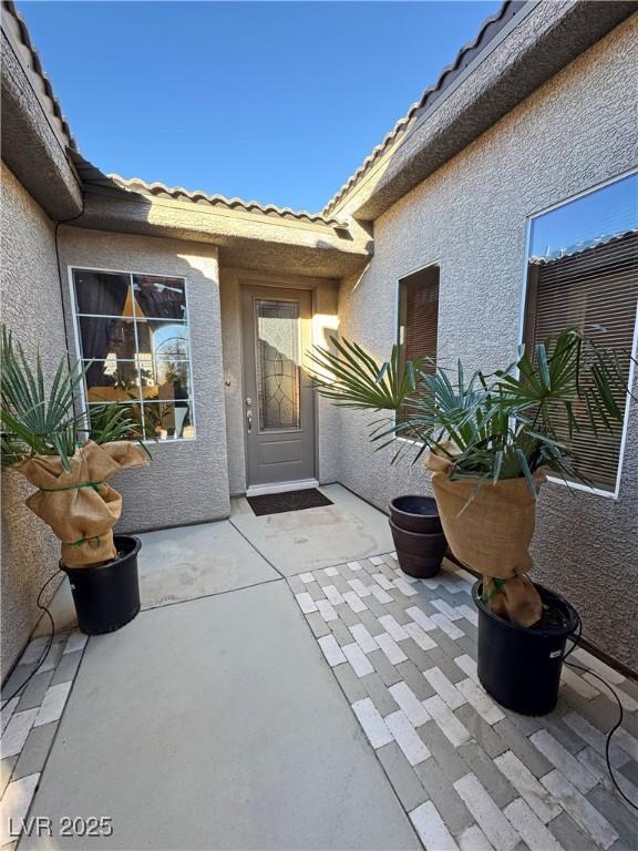 property entrance featuring a patio area