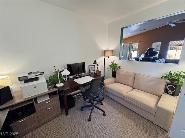 home office with light colored carpet and vaulted ceiling