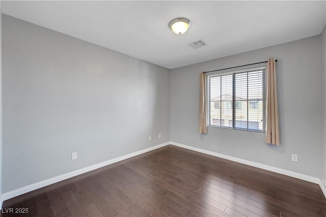 empty room featuring dark wood-type flooring