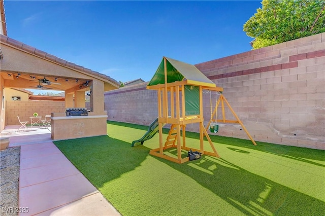 view of play area featuring ceiling fan and a patio