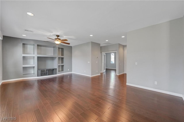 unfurnished living room featuring ceiling fan, dark wood-type flooring, and built in shelves