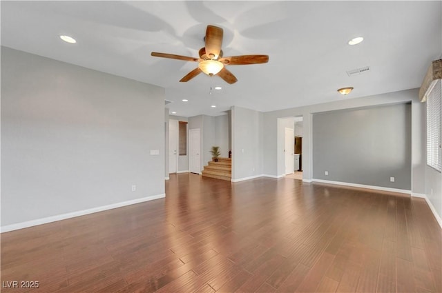 unfurnished living room featuring ceiling fan and dark hardwood / wood-style flooring