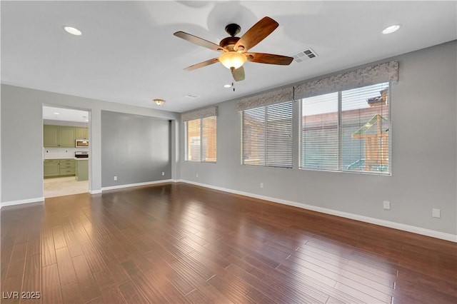 unfurnished room featuring ceiling fan and dark hardwood / wood-style flooring