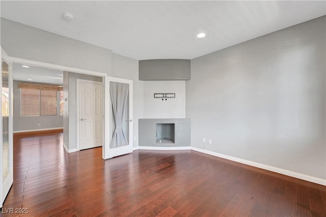 unfurnished living room featuring dark wood-type flooring