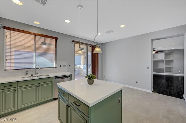 kitchen featuring sink, green cabinets, dishwasher, and pendant lighting