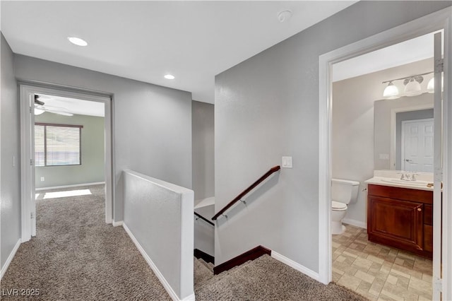 staircase with carpet flooring and sink