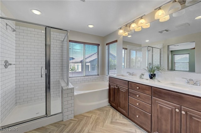 bathroom featuring parquet floors, independent shower and bath, and vanity