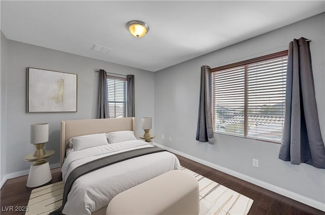 bedroom with dark wood-type flooring