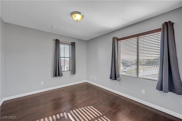 spare room with dark wood-type flooring