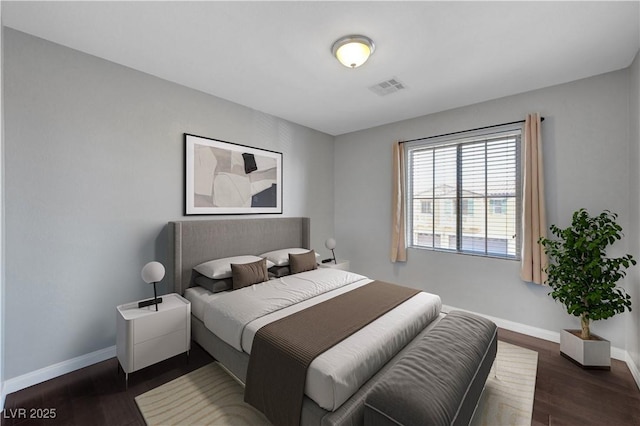 bedroom with dark hardwood / wood-style flooring