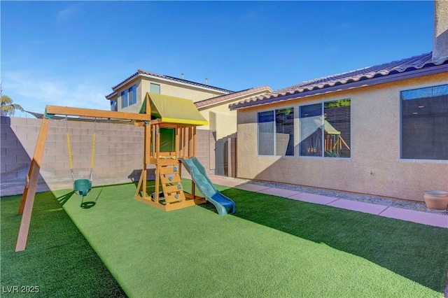 view of jungle gym featuring a lawn