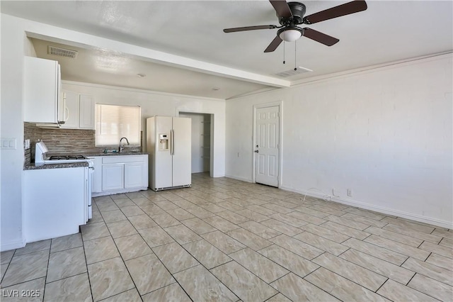 kitchen with white appliances, white cabinets, ceiling fan, beamed ceiling, and sink