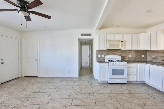 kitchen with white appliances, ceiling fan, white cabinets, and decorative backsplash