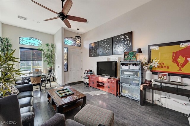 living room with ceiling fan and dark wood-type flooring