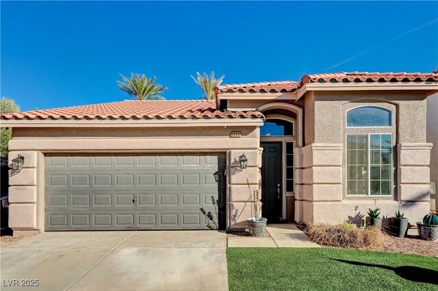 mediterranean / spanish home featuring a garage