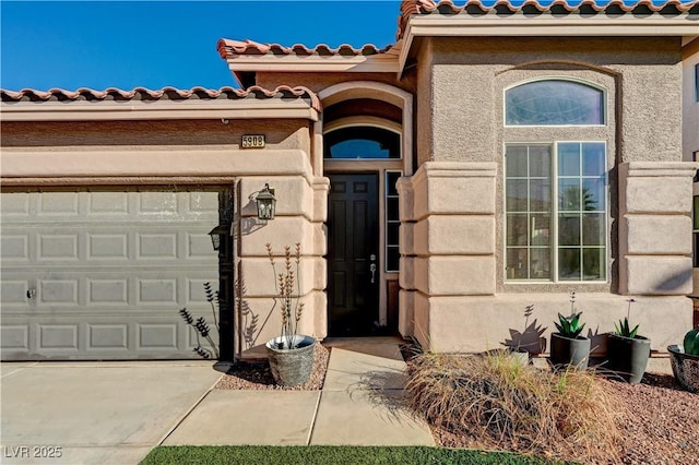 view of exterior entry with a garage