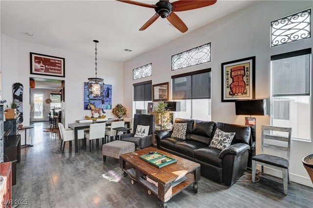 living room featuring wood-type flooring and ceiling fan