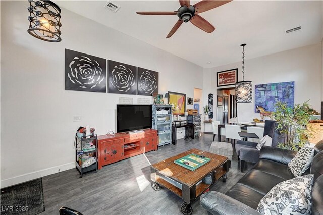 living room with wood-type flooring and ceiling fan