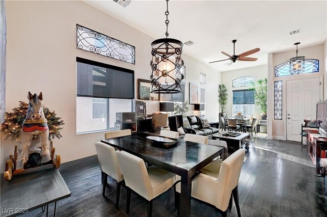 dining space with ceiling fan and dark wood-type flooring