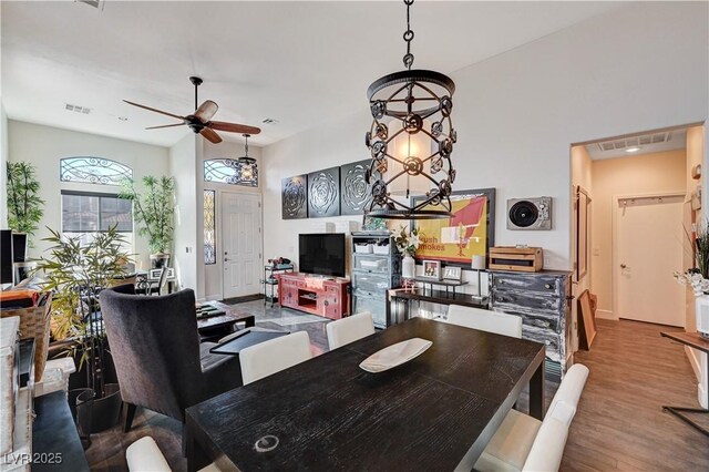 dining area with hardwood / wood-style floors and ceiling fan