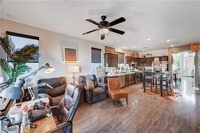 living room featuring light hardwood / wood-style floors and ceiling fan