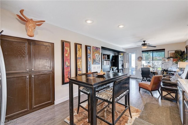 kitchen featuring ceiling fan, dark brown cabinets, and light hardwood / wood-style flooring