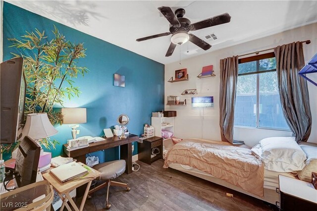 bedroom with ceiling fan and hardwood / wood-style flooring