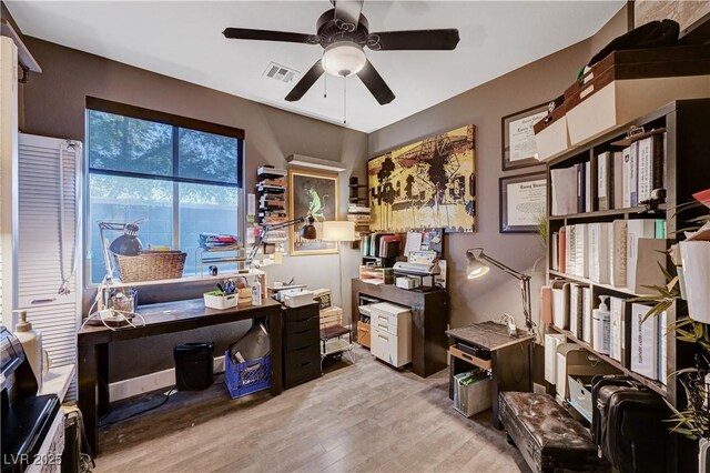 office area with light wood-type flooring and ceiling fan