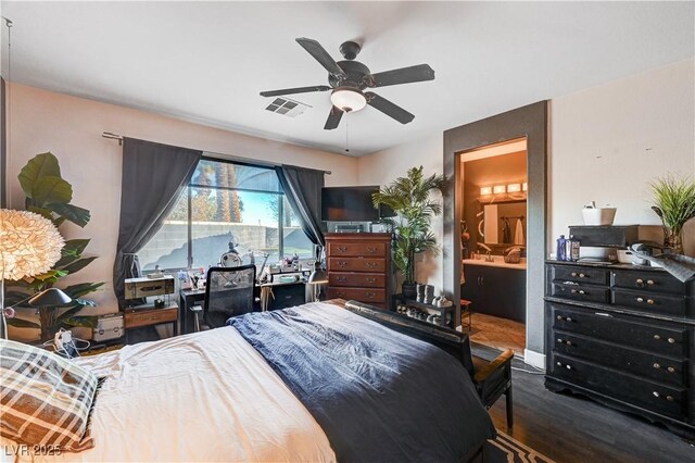 bedroom with ceiling fan, ensuite bath, and dark hardwood / wood-style floors