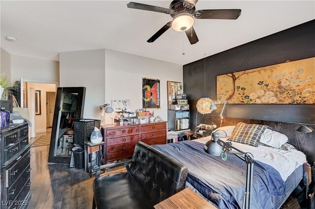 bedroom with ceiling fan and dark hardwood / wood-style floors