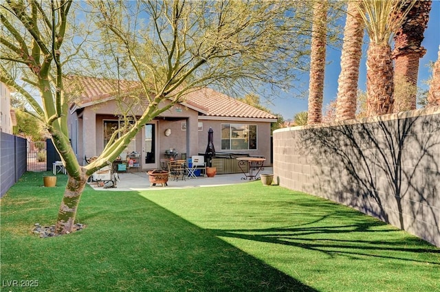 back of property featuring a lawn, a hot tub, and a patio