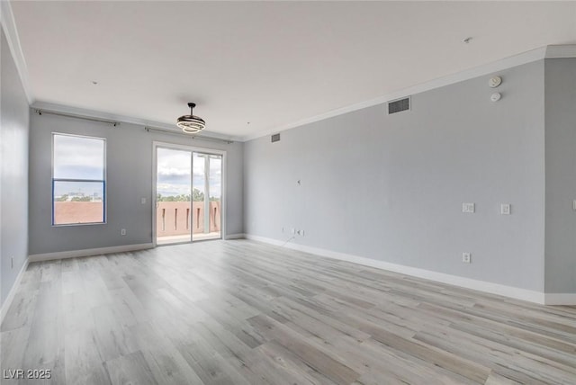 unfurnished room featuring light hardwood / wood-style flooring and crown molding