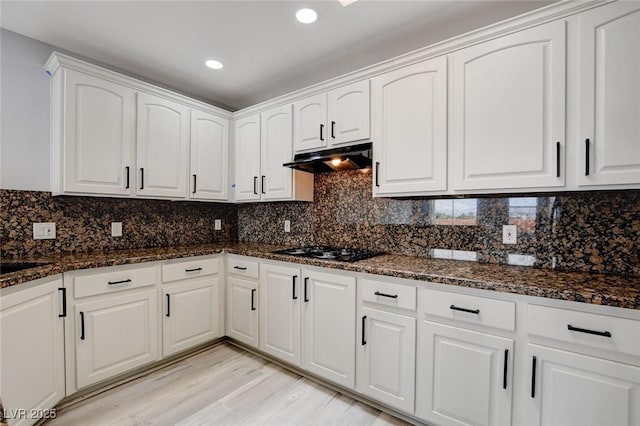 kitchen featuring white cabinets, tasteful backsplash, dark stone counters, and black gas cooktop