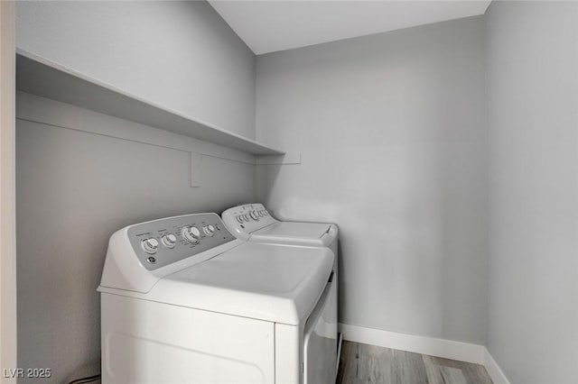 washroom featuring washer and dryer and wood-type flooring