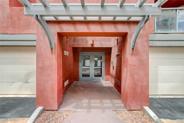 entrance to property featuring french doors and a garage