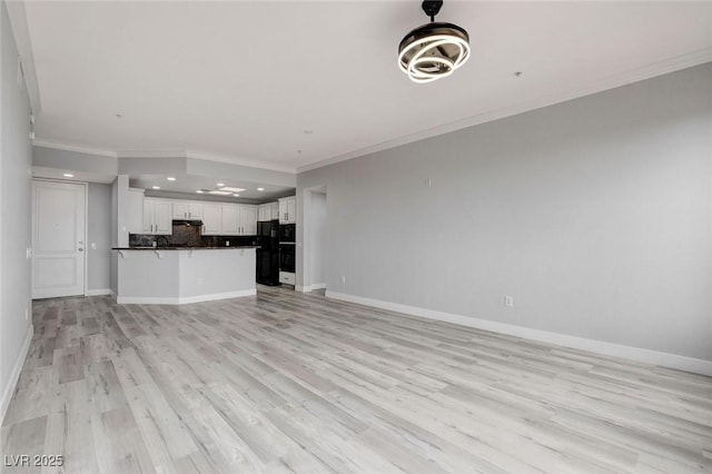 unfurnished living room featuring light hardwood / wood-style floors and crown molding