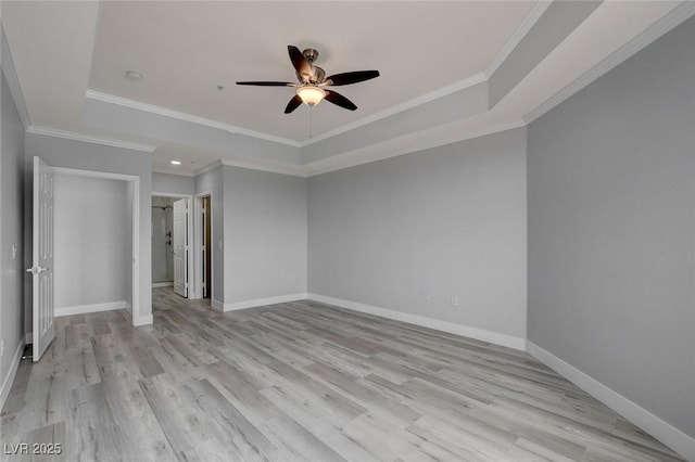 spare room with ceiling fan, crown molding, and a tray ceiling