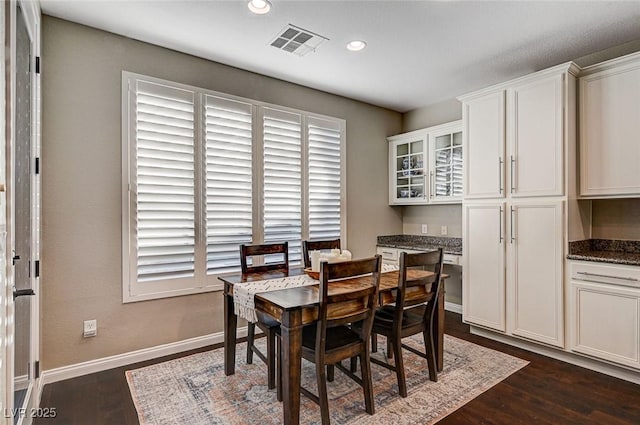 dining space with dark hardwood / wood-style floors