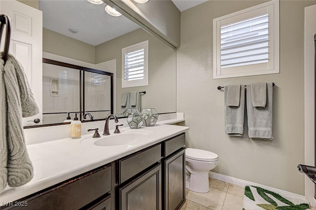 bathroom featuring toilet, a shower with shower door, tile patterned floors, and vanity