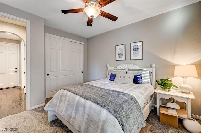 bedroom with ceiling fan, a closet, and carpet floors